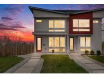 Modern townhome with gray and red exterior, clean landscaping, and inviting entryways at 4390 Osage St, Denver, CO 80211