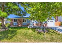Charming brick-accented home with a well-manicured lawn and mature tree at 4533 S Devinney St, Morrison, CO 80465