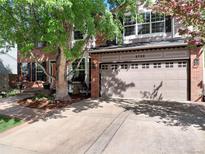 Charming two-story home with a brick facade, attached garage, and mature trees at 2732 Flint Ct, Superior, CO 80027