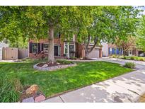 Charming two-story brick home featuring mature trees and a well-manicured lawn and front yard at 2732 Flint Ct, Superior, CO 80027