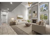 Bright living room boasts soaring ceilings, fireplace, and large windows offering plenty of natural light at 2732 Flint Ct, Superior, CO 80027