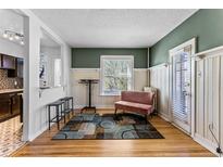 Cozy living room with hardwood floors, a modern rug, and a cute pink velvet love seat at 1356 N Pearl St # 202, Denver, CO 80203