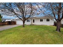 Charming single-story home with a well-maintained lawn and mature trees creating curb appeal at 13388 Alcott Cir, Broomfield, CO 80020