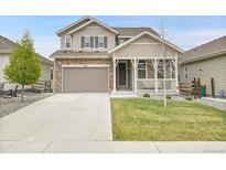 Charming two-story home features a welcoming front porch and a well-maintained lawn at 4552 S Perth Ct, Aurora, CO 80015