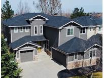 Charming two-story home featuring a three-car garage, stone accents, and a well-maintained lawn at 10774 Chadsworth Ln, Highlands Ranch, CO 80126