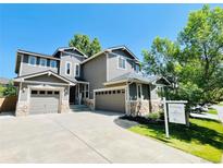 Charming two-story home with a three-car garage and meticulously landscaped front yard at 10774 Chadsworth Ln, Highlands Ranch, CO 80126