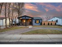 Charming home with a covered front porch, lovely brick driveway, and well-maintained lawn at 4510 W 4Th Ave, Denver, CO 80219