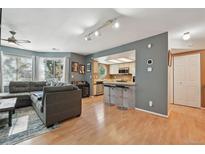 Inviting living room featuring a large sectional sofa, wood floors, and abundant natural light at 12655 E Pacific Cir # C, Aurora, CO 80014