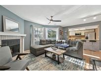 Inviting living room features a cozy fireplace and sliding glass doors to outdoor space at 12655 E Pacific Cir # C, Aurora, CO 80014