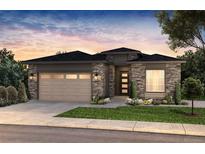 Beautiful single-story home featuring stone accents, a two-car garage, and professional landscaping at 22143 E Rocky Top Pl, Aurora, CO 80016