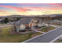 Luxury home with mountain views, expansive backyard, and a long driveway at 16394 W 77Th Ln, Arvada, CO 80007