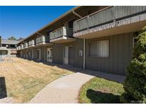Charming condominium with balconies, green siding and well maintained common outdoor area at 9925 W 20Th Ave # 2, Lakewood, CO 80215