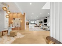 Spacious living room featuring modern decor, wood accents, and large windows for natural light at 1001 S Adams St, Denver, CO 80209