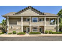 Charming condo building with stone accents, private patios, and well-maintained landscaping at 4385 S Balsam St # 6-103, Littleton, CO 80123