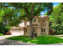 Charming two-story home featuring a well-maintained lawn, mature trees, and a spacious two-car garage, perfect for families at 5530 Racquet Ln, Boulder, CO 80303