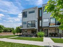 Modern townhome features sleek architectural details and private balcony perfect for outdoor living at 7066 W 13Th Ave, Lakewood, CO 80214