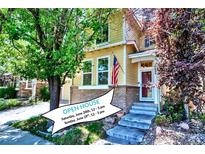 Charming two-story home featuring a brick foundation, inviting front porch, and well-manicured landscaping at 10609 Abilene St, Commerce City, CO 80022