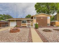 Charming brick home with a well-manicured lawn and inviting front porch at 6072 Pierson Ct, Arvada, CO 80004