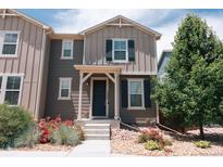 Charming two-story home featuring neutral paint, a welcoming front porch, and well-maintained landscaping at 15861 E Otero Ave, Centennial, CO 80112
