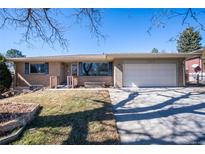 Charming single-story brick home with an attached two car garage and a well-maintained front yard at 1849 S Van Gordon Ct, Lakewood, CO 80228