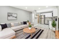 Open living room featuring L-shaped sofa and modern coffee table at 2707 Valmont Rd # 106B, Boulder, CO 80304