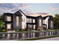 Modern townhome exterior showcasing stylish architecture, dark siding, and well-manicured landscaping at 6912 Huddersfield Ln, Castle Pines, CO 80108