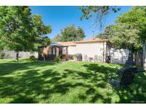 This home boasts a lush, well-maintained backyard, perfect for entertaining or relaxing outdoors at 5215 S Washington St, Littleton, CO 80121