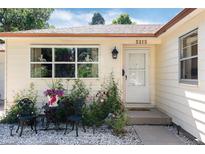 Charming front entrance featuring decorative chairs, a small table, and blooming flowers for a welcoming aesthetic at 5215 S Washington St, Littleton, CO 80121