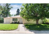 Charming single-story home with a well-maintained lawn and mature shade tree in a desirable neighborhood at 5215 S Washington St, Littleton, CO 80121
