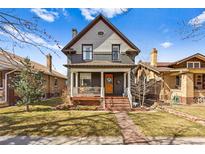 Charming two-story home with a covered front porch and well-maintained lawn, ideal for comfortable living at 621 S Sherman St, Denver, CO 80209