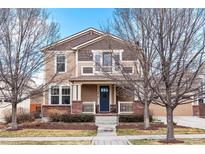 Charming two-story home with brick accents, front porch, and a well-maintained front yard at 3410 Uinta St, Denver, CO 80238