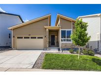 Charming home featuring a two-car garage, landscaped front yard, and stylish architectural details at 268 Simmental Loop, Castle Rock, CO 80104