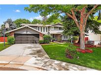 Charming two-story home with a well-manicured front yard and a spacious two-car garage at 6338 S Oneida Ct, Centennial, CO 80111