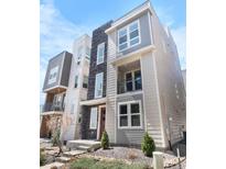Modern two-story townhome featuring a private balcony and stone accents for added curb appeal at 11918 Mountview Ln, Broomfield, CO 80021