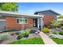 Charming single-story brick home with a cozy porch and beautifully landscaped front yard at 6040 Taft Ct, Arvada, CO 80004