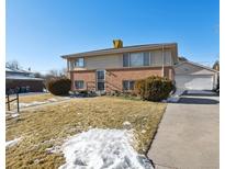 Ranch style home with attached garage and mature landscaping at 9647 Pelon Dr, Northglenn, CO 80260