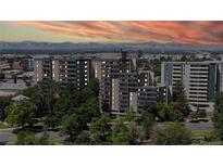 Beautiful condominium building with lush landscaping and mountain views at sunset at 601 W 11Th Ave # 1109, Denver, CO 80204
