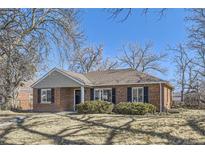 Charming brick home featuring well-maintained landscaping, windows with shutters, and a welcoming entryway at 2920 Ivy St, Denver, CO 80207