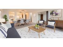 Bright living room featuring modern decor, stylish furniture, and an open floor plan into the kitchen at 14152 E Linvale Pl # 509, Aurora, CO 80014