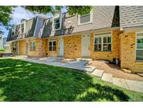 Charming brick townhouse featuring well-maintained landscaping and inviting front entrances at 1517 S Owens St # 5, Denver, CO 80232
