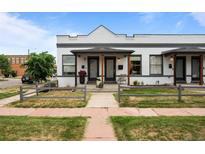 Charming townhome featuring brick facade, inviting front porch, and well-manicured lawn at 3003 California St, Denver, CO 80205
