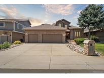 Charming two-story home featuring a brick facade, three-car garage, and well-maintained landscaping at 1123 Oakhurst Dr, Broomfield, CO 80020