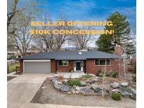 Charming single-story brick home with manicured front yard and an attached garage, offering $10K concession at 5743 Field St, Arvada, CO 80002