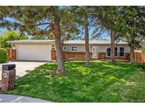 Charming ranch home with mature trees, a well-maintained lawn, and a two-car garage at 7773 Brentwood Ct, Arvada, CO 80005