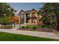 Stunning contemporary home featuring a manicured lawn, modern fence, and elegant architectural details at 257 Jackson St, Denver, CO 80206