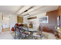 This dining room features a modern light fixture and unique decor at 775 S Alton Way # 3D, Denver, CO 80247