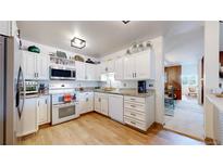 Well-lit kitchen with white cabinetry, stainless steel appliances, and granite countertops at 775 S Alton Way # 3D, Denver, CO 80247