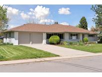 Charming home featuring a lush green lawn and a convenient two-car garage at 3775 S Forest Way, Denver, CO 80237