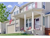 Inviting two-story home featuring a covered front porch and a well-maintained lawn at 1673 Morningview Ln, Castle Rock, CO 80109