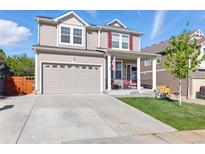 Charming two-story home with a well-manicured lawn and an attached two-car garage at 1673 Morningview Ln, Castle Rock, CO 80109